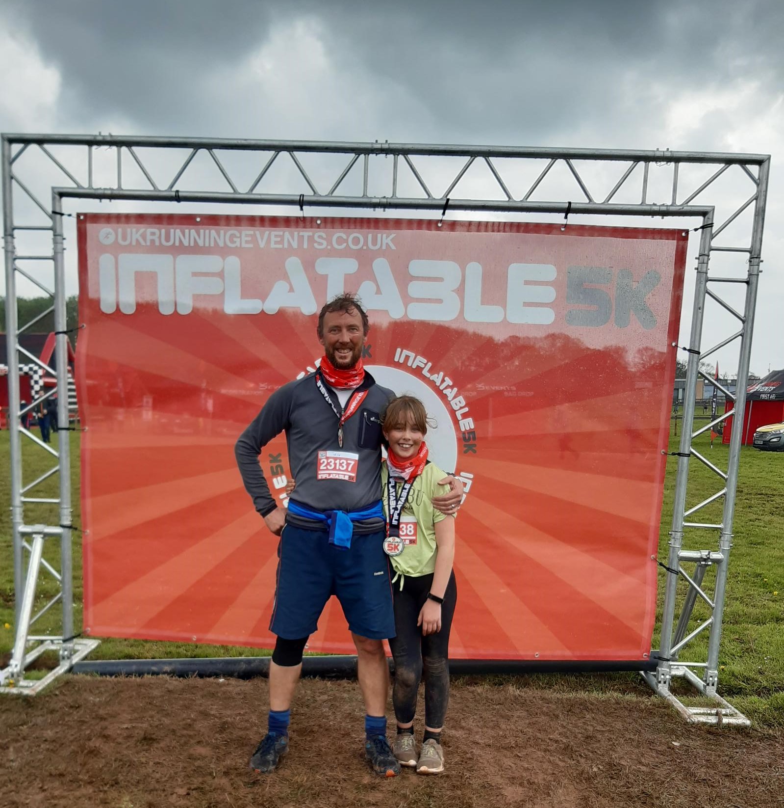 Ben and his daughter Alexandra in front of the Inflatable 5k banner