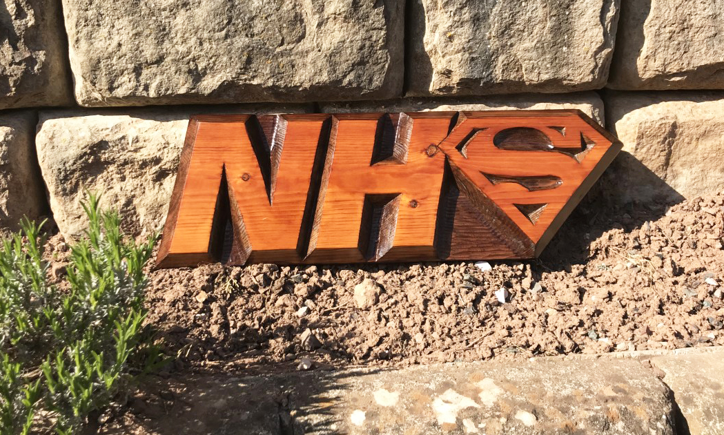 Carved NHS superhero plaques donated